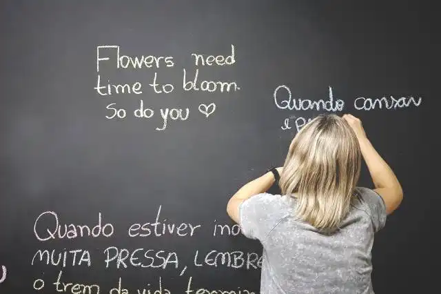 person writing on chalkboard
