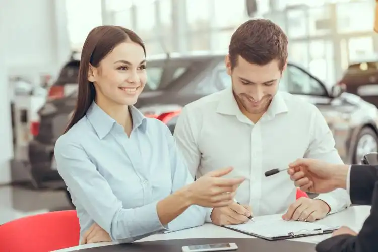 Young man and woman in a car rental service lease contract