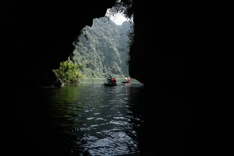 a group of people in a canoe in a cave