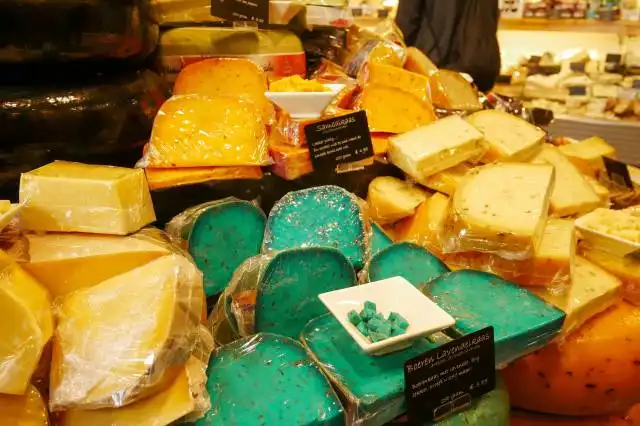 a display in a store filled with lots of different types of cheese