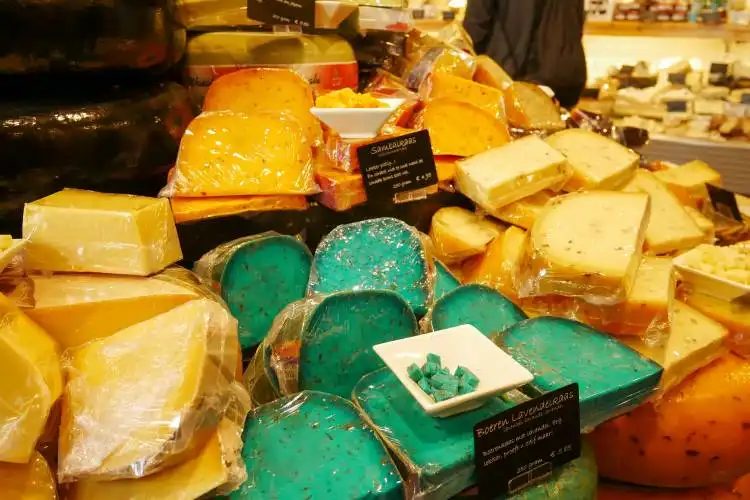 a display in a store filled with lots of different types of cheese
