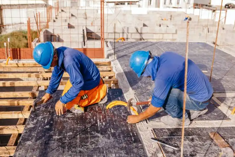 a couple of men working on a roof