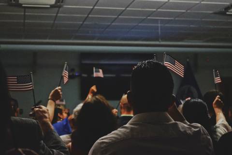 people holding flag of U.S.A miniature