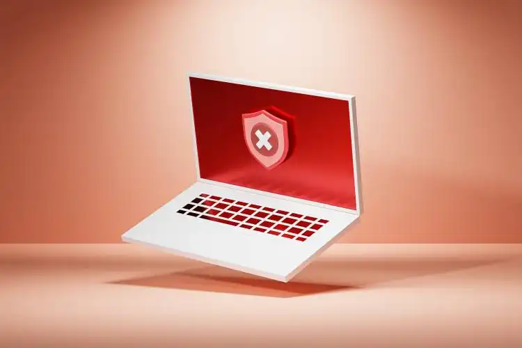 a laptop with a red shield on the screen