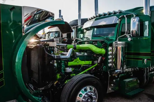 a close up of the front of a green semi truck