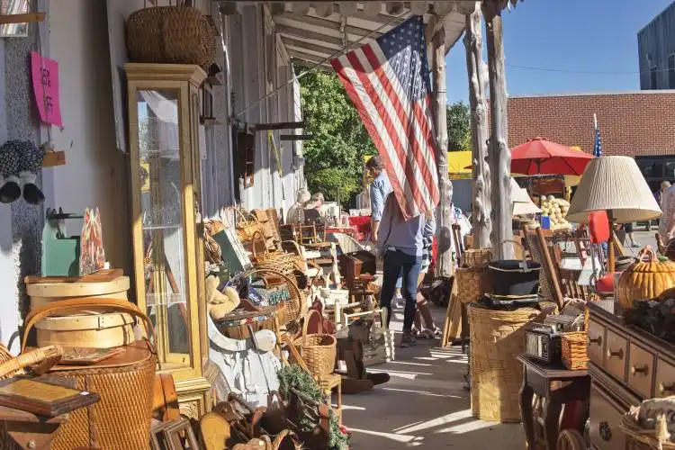 a man walking down a street next to a store