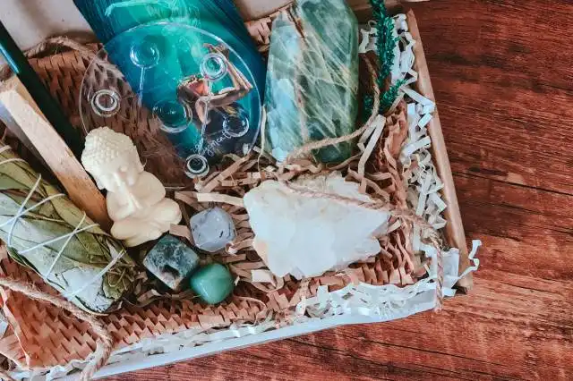 a wicker box filled with different items on top of a wooden floor