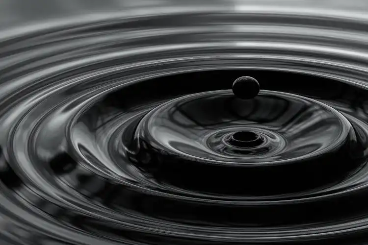 a black and white photo of a water drop