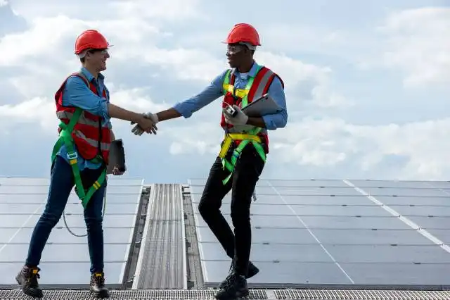 Engineer working setup Solar panel at the roof top. Engineer or worker work on solar panels or solar cells on the roof of bus