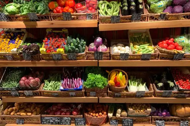 assorted fruits on brown wooden rack