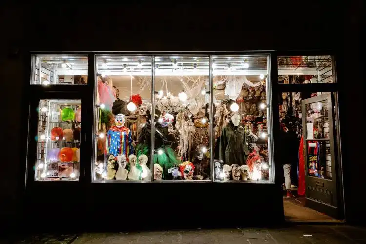 a store front with a lot of mannequins in the window