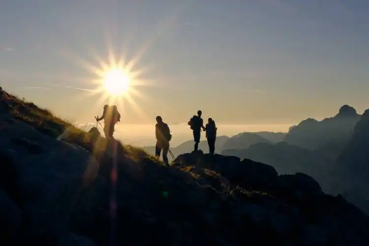 four person on mountain during daytime