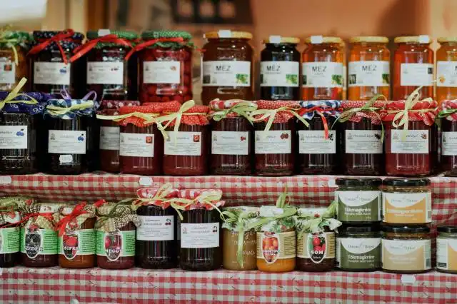 clear glass jars on brown wooden shelf
