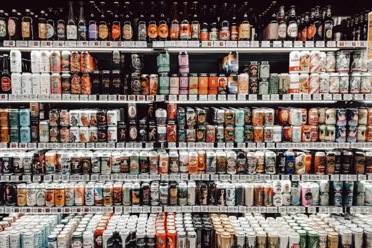 assorted bottles on brown wooden shelf