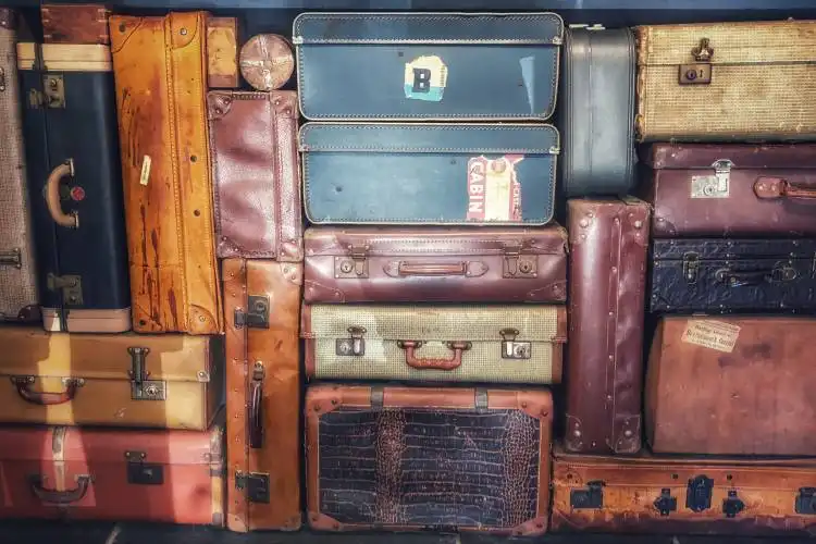 low light photography of stacked luggage