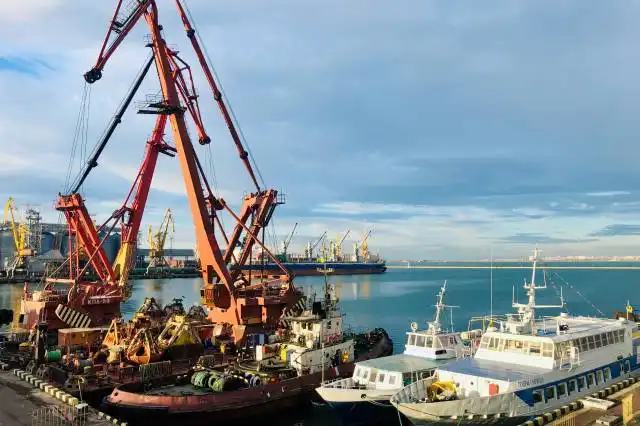 orange and black crane near body of water during daytime