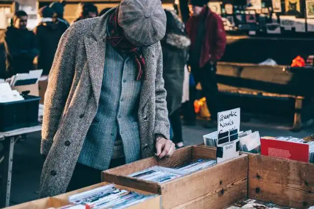 person looking in box filled with books