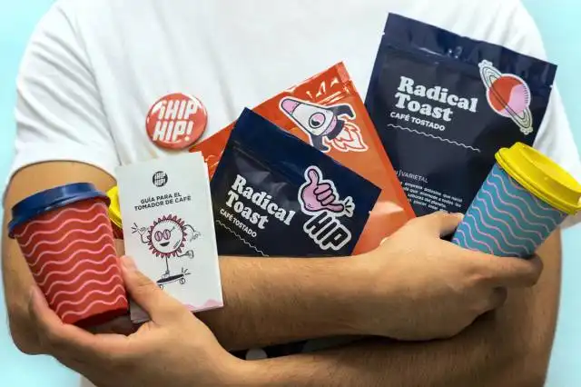 a man holding a cup of coffee and some snacks