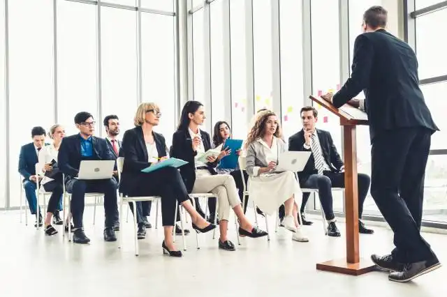 Group of business people meeting in a seminar conference . Audience listening to instructor in employee education training se