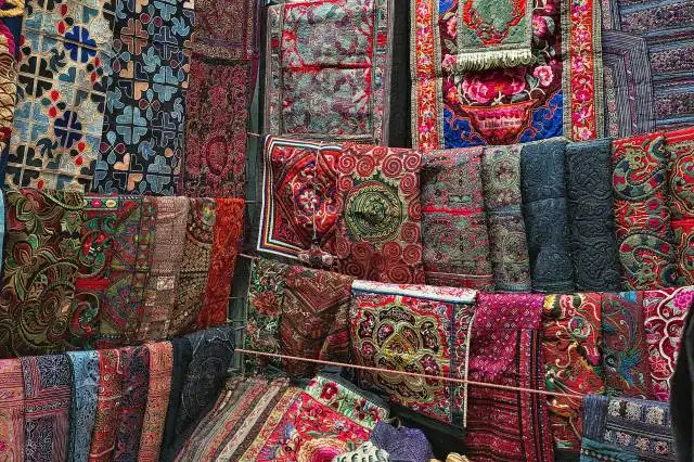 a display of colorful carpets and rugs for sale