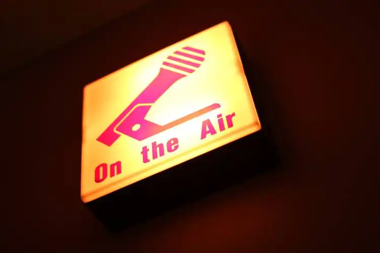symbol of microphone with words on the air