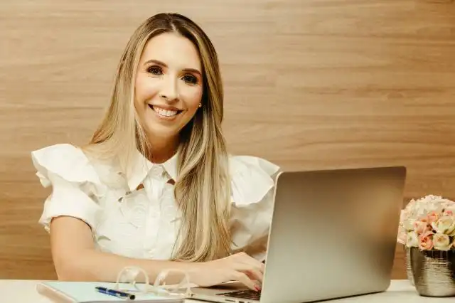 a woman sitting in front of a laptop computer