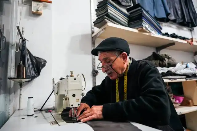 a man is working on a sewing machine