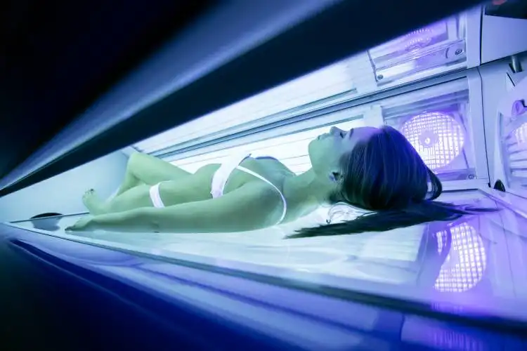 Beautiful sexy brunette sunbathing in solarium