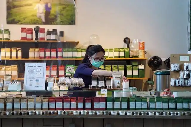 woman in blue and black long sleeve shirt wearing black framed eyeglasses
