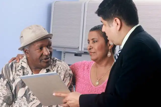 man in black suit jacket and woman in pink and white floral dress