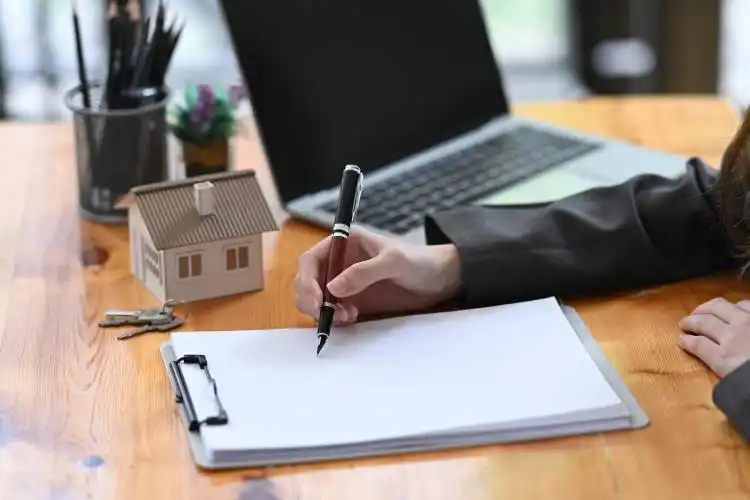 Real estate agent woman analyzing real estate investment data on wooden table.