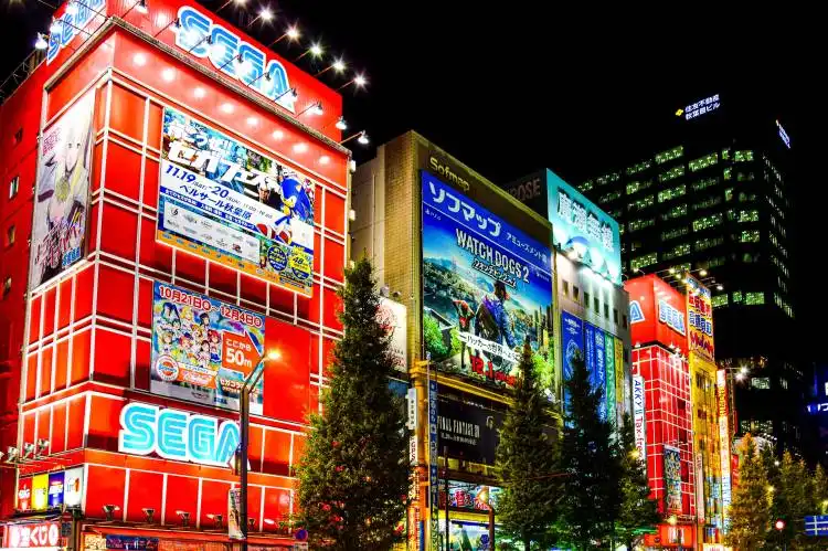 a city street at night with a lot of tall buildings