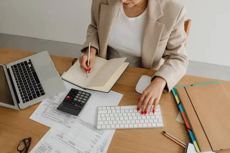 a woman sitting at a desk working on a computer