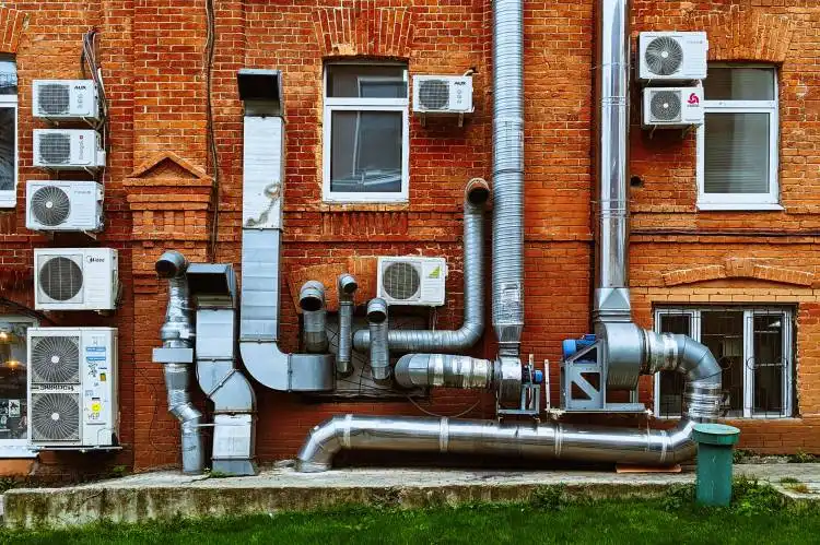 a building with a bunch of pipes on the side of it