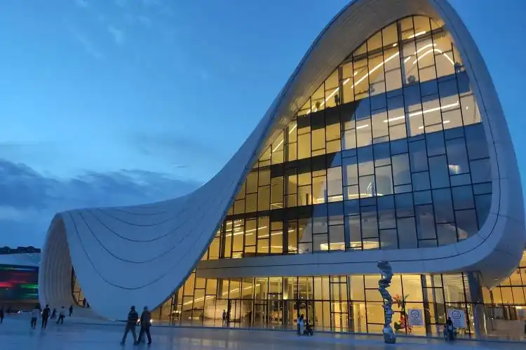 people walking on the street near the glass building during daytime