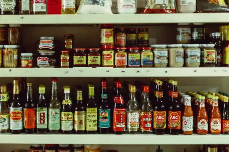 assorted bottles on brown wooden shelf