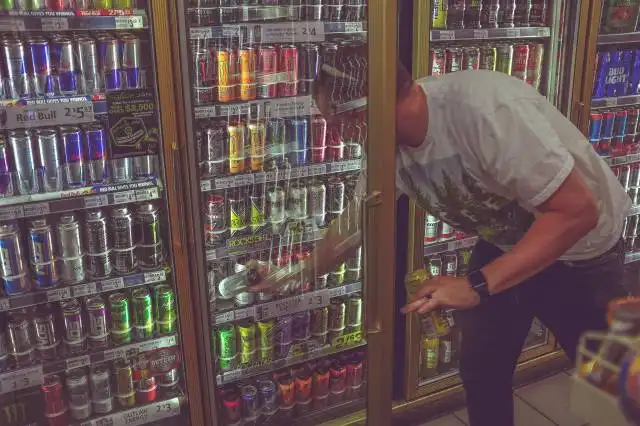 man getting can in beverage cooler
